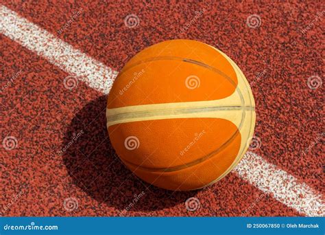 Orange Ball For Basketball Lying On The Sport Courtsport Red Court