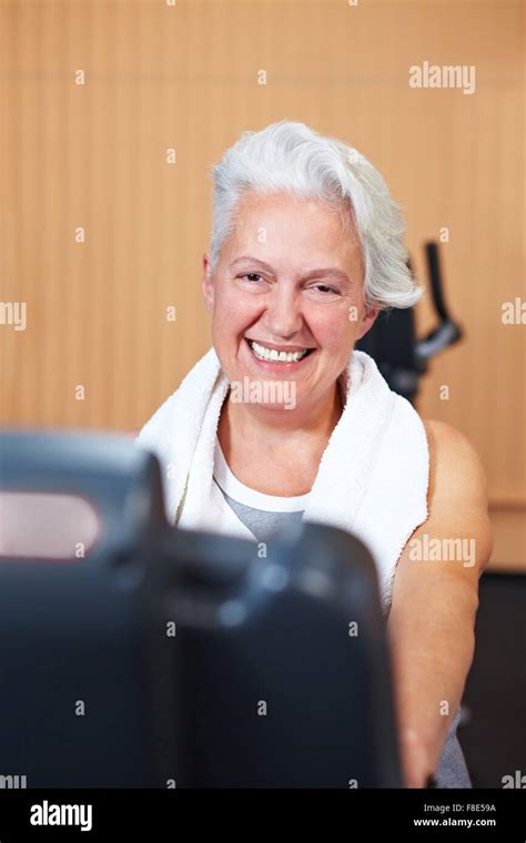 Happy Smiling Senior Woman Exercising In A Gym Stock Photo Alamy