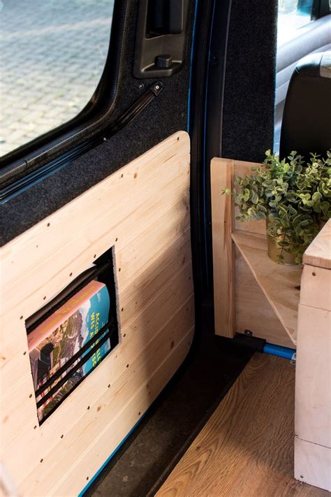 The Interior Of A Van With Wood Paneling And Planter Boxes On The Side