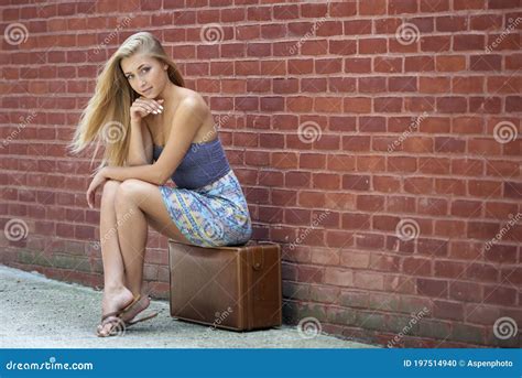 Beautiful Blonde Woman In Strapless Sundress With Vintage Suitcase