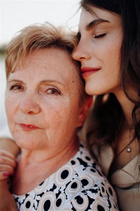 Mother And Daughter Standing Close To Each Other And Smiling · Free