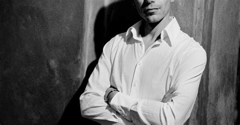 man  white dress shirt standing  wall  stock photo