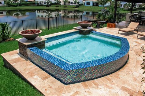 Swim Spa With Custom Fire Bowls And Outdoor Kitchen In Cooper City