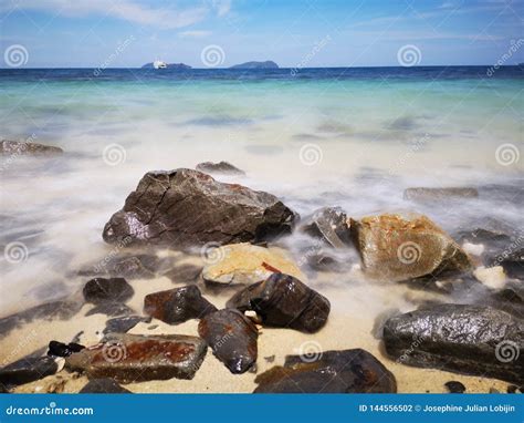 Las Ondas Y Las Rocas Lisas Sedosas Hermosas De Agua En La Orilla De