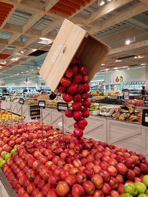 Apples Are Stacked On Top Of Each Other In A Produce Section At A