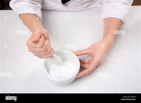 Closeup Of Hands Crushing Powder On Mortar With Pestle Stock Photo Alamy