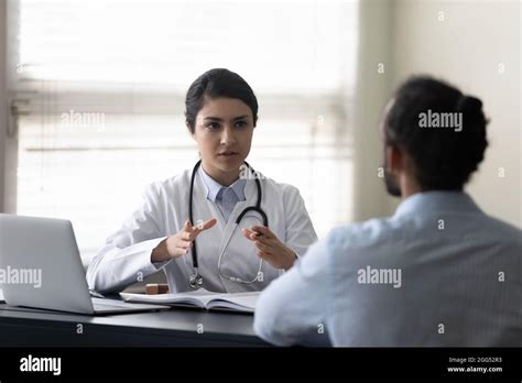 Young Female Indian Doctor Consulting African Patient Stock Photo Alamy