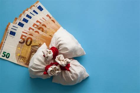 Premium Photo | Euro banknotes and bags with coins