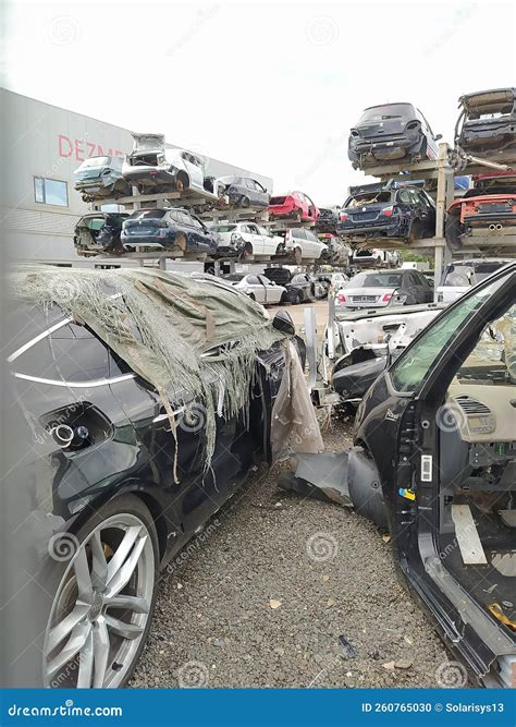 Buzau, Romania - September 12, 2022: Old Wrecked Cars in Junkyard