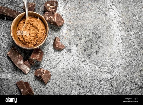 Chunks Of Chocolate With Cocoa Powder On A Rustic Background Stock