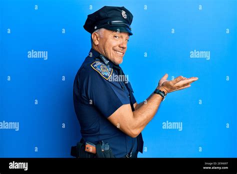 Handsome Middle Age Mature Man Wearing Police Uniform Pointing Aside