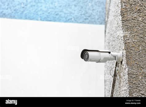 Modern Cctv Camera Installed On Wall Of Building Outdoors Stock Photo