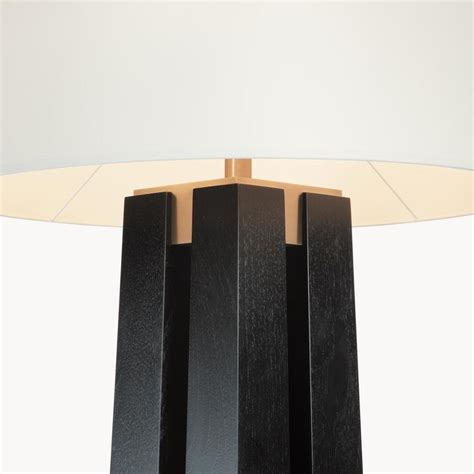 A Black Table Lamp Sitting On Top Of A White Floor