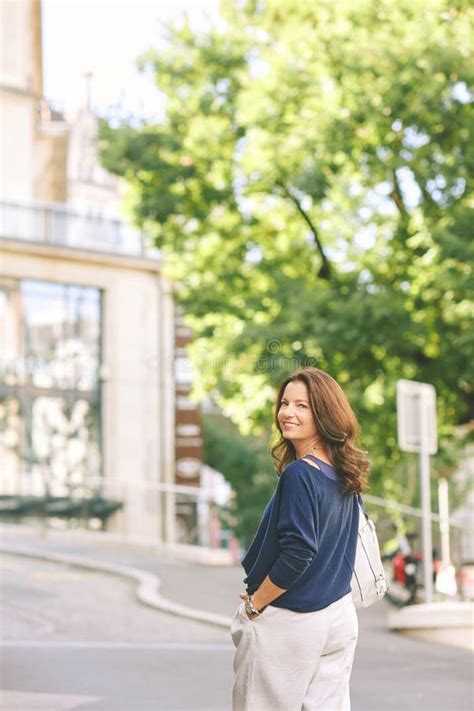 Outdoor Portrait Of Happy Mature Woman Posing On The Street Stock