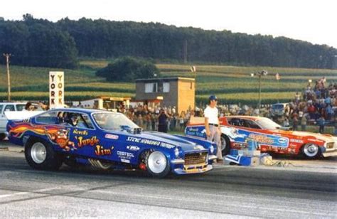 Two Drag Cars With Flames Painted On Them