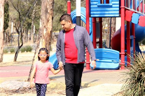 Single Dad Walks Through The Park With His 5 Year Old Latina Daughter Over The Weekend To
