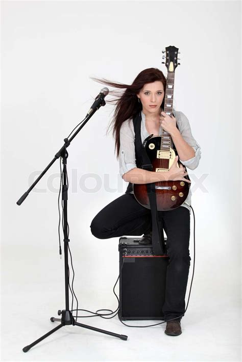 Musician Hugging Her Guitar And Posing With Her Equipment Stock Image Colourbox