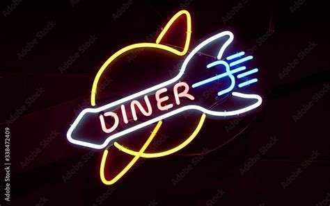 A Vintage Retro American Style Neon Sign Advertising A Diner A Dark