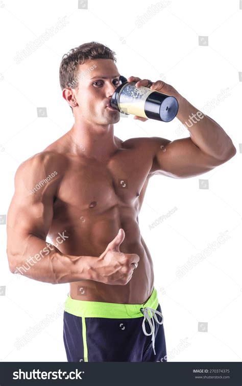 Muscular Shirtless Male Bodybuilder Holding Protein