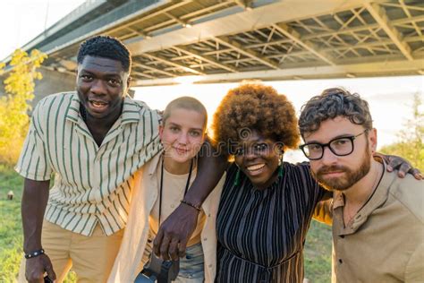 Outdoor Portrait Of Multicultural Group Of Four People Looking At