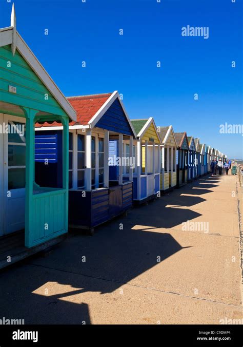 Traditional Brightly Coloured Wooden Beach Huts On The Promenade At