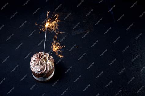 Premium Photo Delicious Birthday Cupcake With Firework Candle On