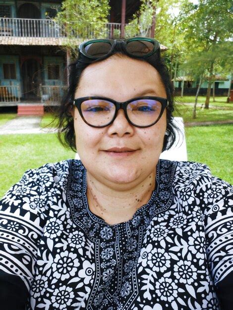 Premium Photo Portrait Of Smiling Mature Woman Wearing Eyeglasses At Park