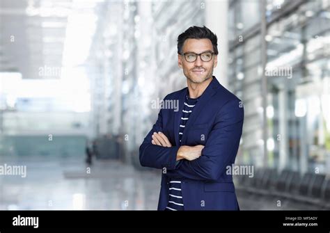 Portrait Of Stylish Businessman With Stubble Wearing Blue Suit And