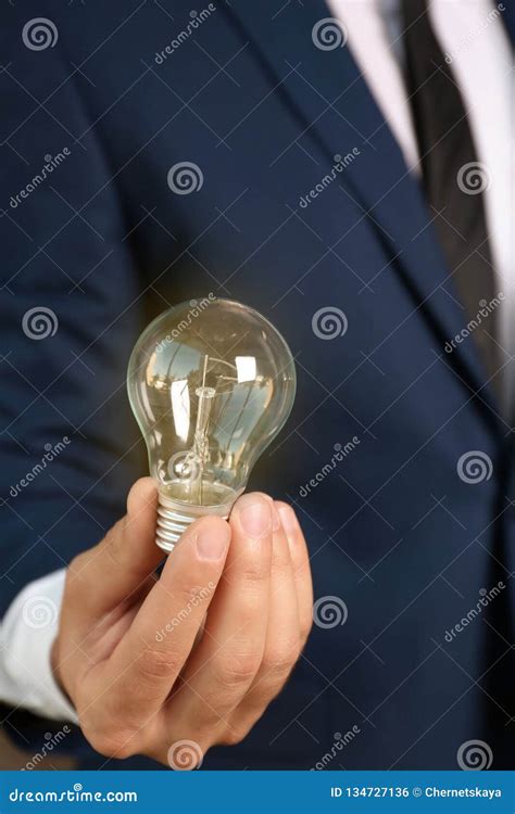 Businessman In Suit Holding Lamp Bulb Stock Photo Image Of Lightbulb