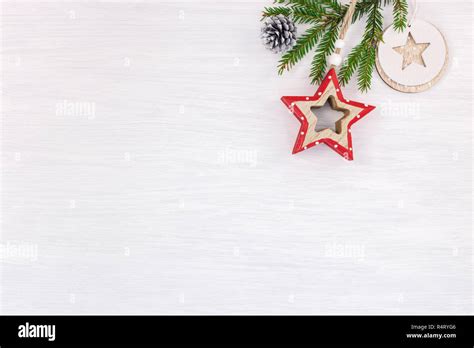 White Wooden Background With Green Christmas Tree Branch And Wooden