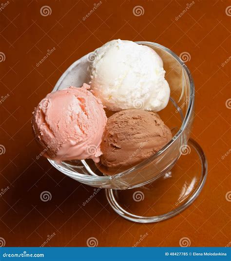 Three Scoops Of Chocolate Strawberry And Vanilla Ice Cream In G Stock