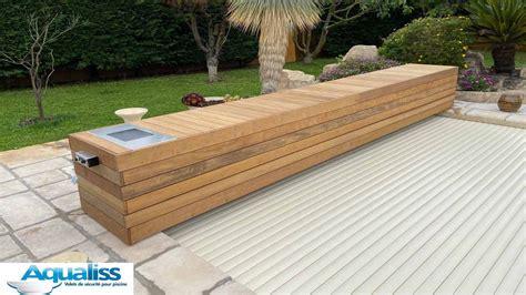 A Large Wooden Bench Sitting On Top Of A Patio Next To A Lush Green Field