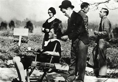 Charlie Chaplin On Location Attending To The Hair Of Leading Lady