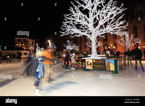 Panned camera effect on People skating on the Christmas Ice rink ...