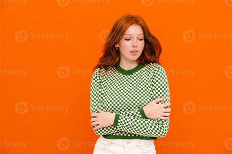 Young Ginger Haired Woman In Plaid Sweater Looking Downward 5179874