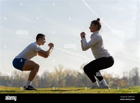 Two Amazing And Attractive Fit Friends Are Doing Squad Exercise On The