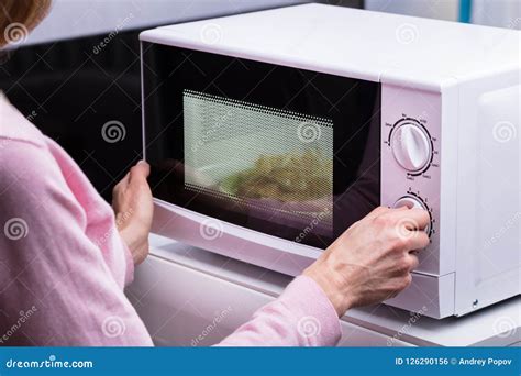 Woman Using Microwave Oven For Heating Food Stock Photo Image Of