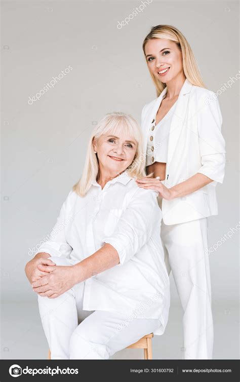 Smiling Blonde Grandmother Sitting Chair Granddaughter Total White Clothes Isolated Stock Photo