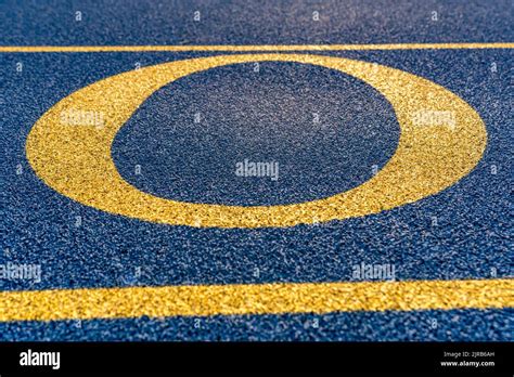 Close Up The Letter Initial O On A New Blue Running Track With Yellow