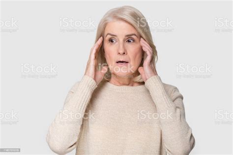 Headshot Of Aged Woman Feeling Scared Isolated On Gray Background Stock