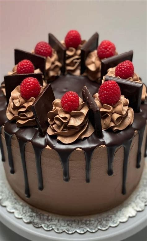 A Chocolate Cake With Raspberries On Top