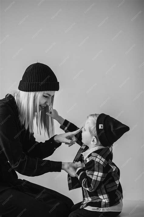 Premium Photo Happy Mother And Her Son Smiling And Embracing In Room