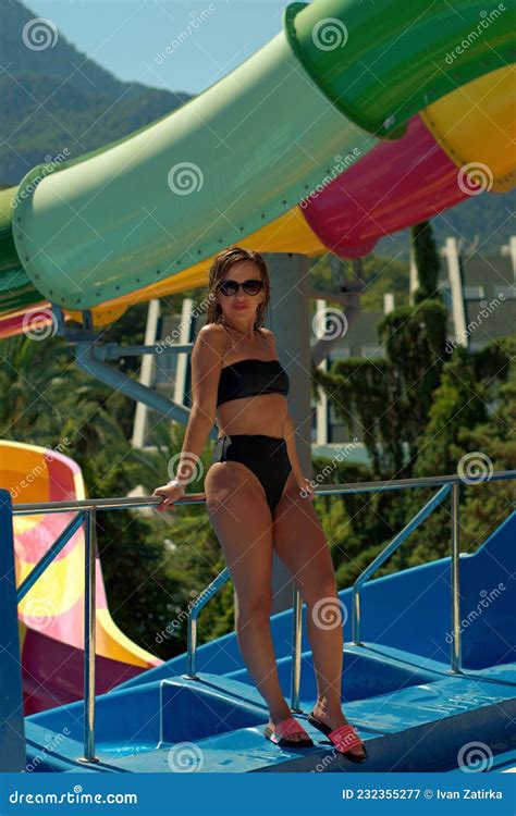 Girl At The Height Of The Water Park Posing In A Swimsuit Stock Image