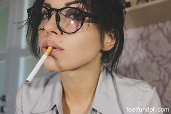 Amazing Brunette Hottie Smoking A Cigarette While Showing Her Cleavage Photos