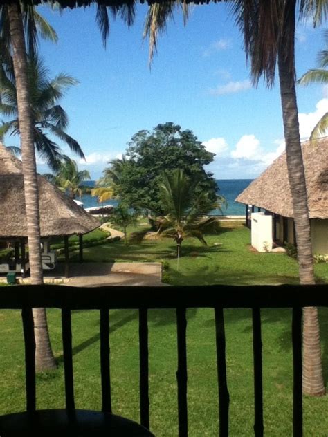 A View From The Balcony Of A Tropical Resort With Palm Trees And