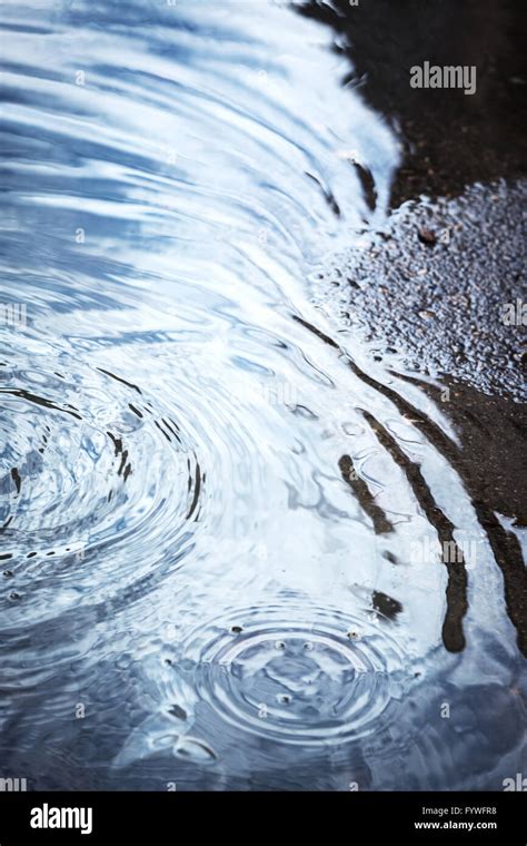 Rain Puddles On Pavement Stock Photo Alamy