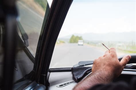 Premium Photo Driver Smoking While Driving