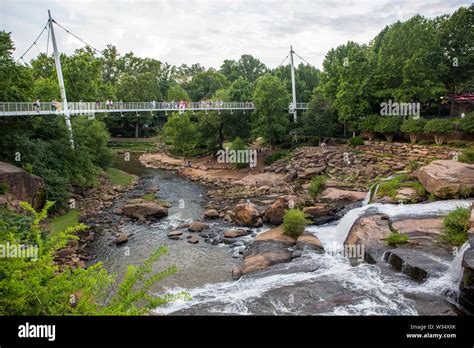 Visitors To Falls Park Linger On Liberty Bridge Overlooking The Reedy