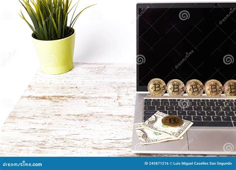 Bitcoin And Dollar Bills On A Laptop On An Office Desk Payment With