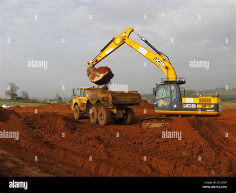 Tracked Jcb Backhoe Excavator Loading Truck On Highway Construction